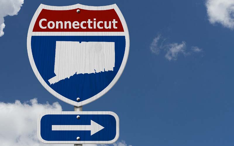 A sign pointing towards the state of Connecticut. 