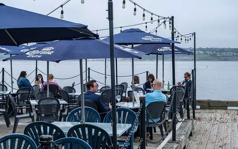 People dining at a waterfront restaurant in CT.