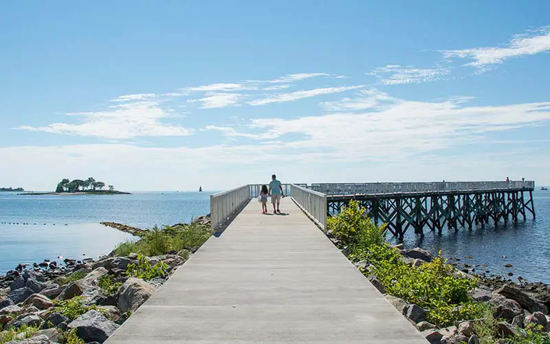 People walking on a boardwalk in CT.