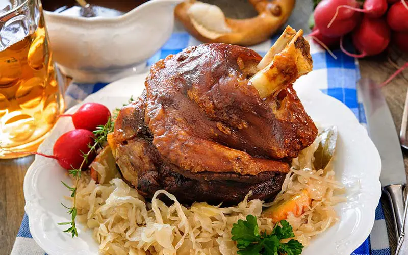 A plate of sauerkraut and meat at a German restaurant in CT.