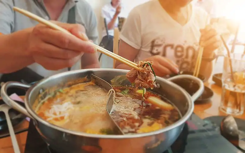 People eating a bowl of hot pot in CT.