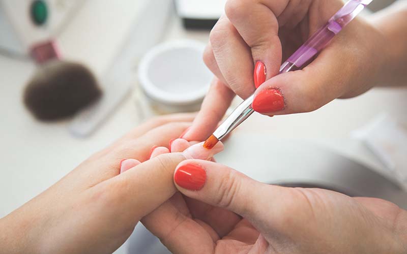 A women getting here nails painted at a nail salon in CT. 