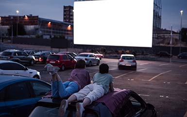 People watching a movie at a drive in movie theater CT.