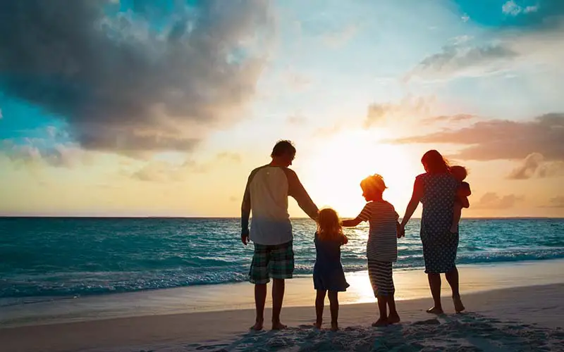 A family walking on the beach in CT.