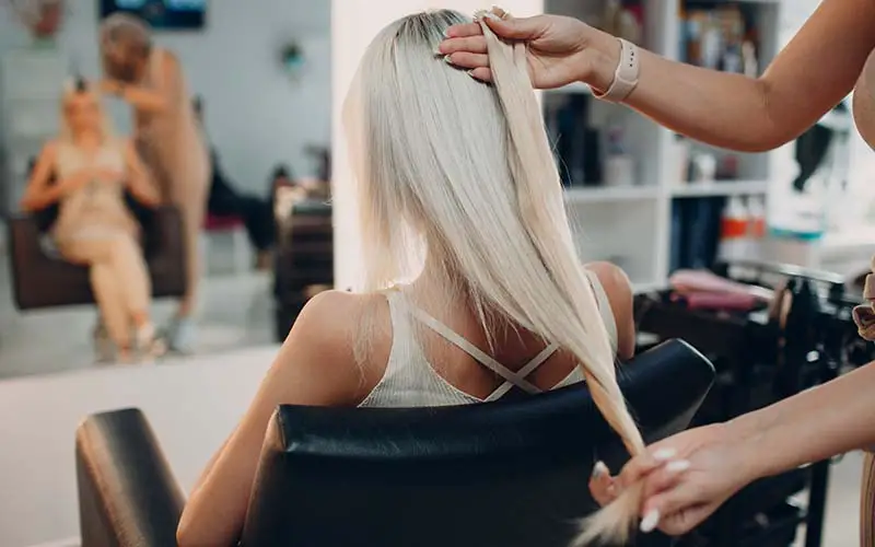 A girl getting here hair done at a hair salon in CT.